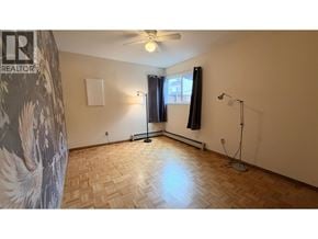 Vancouver apartment for rent - A room with a wooden floor and a ceiling fan.