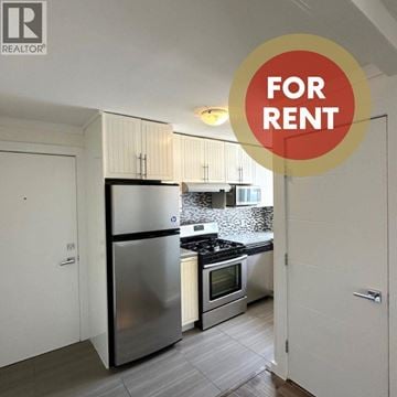 North Vancouver apartment for rent - A kitchen with a refrigerator, oven, and microwave is for rent.