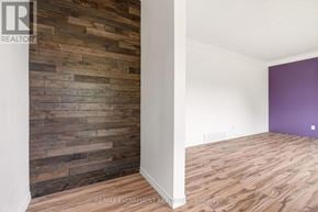 St. Catharines (Glendale/Glenridge) apartment for rent - A room with a wooden wall and a purple wall.