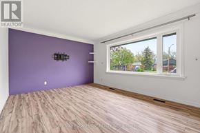 St. Catharines (Glendale/Glenridge) apartment for rent - A room with purple walls and wooden flooring.