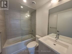 Toronto (Waterfront Communities) condo for rent - A bathroom with a tub, toilet, and sink.