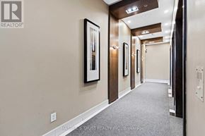 Toronto (Waterfront Communities) condo for rent - A hallway with a carpeted floor, walls, and ceiling with lights.