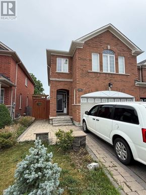 Richmond Hill (Westbrook) apartment for rent - A white car is parked in front of a brick house.