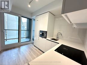 Toronto (Kensington-Chinatown) condo for rent - A modern kitchen with a stove top oven and a sink.