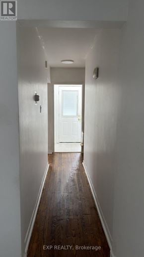 Toronto (Cliffcrest) fourplex for rent - A hallway with a white door at the end.