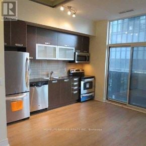 Toronto (Church-Yonge Corridor) condo for rent - A kitchen with a refrigerator, microwave, oven, and dishwasher.