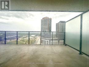 Toronto (Bayview Village) condo for rent - A balcony with a view of the cityscape and a building with the logo "REALTOR" on the railing.