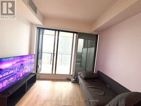 Toronto (Bayview Village) condo for rent - A living room with a flat screen TV and sliding glass doors.