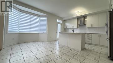 East Gwillimbury (Holland Landing) apartment for rent - A kitchen with white cabinets and a tiled floor.
