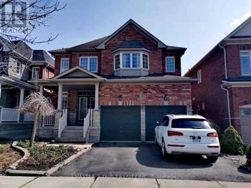 Aurora apartment for rent - A white car is parked in front of a brick house.