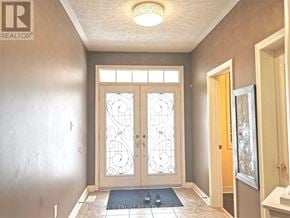 Aurora apartment for rent - A foyer with a glass door and a carpet on the floor.