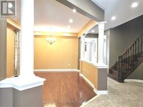 Aurora apartment for rent - A well-lit room with a staircase and a chandelier.