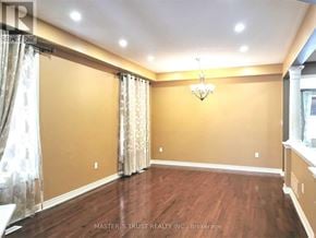 Aurora apartment for rent - A room with wooden floors and a chandelier.