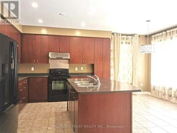 Aurora apartment for rent - A kitchen with brown cabinets and black appliances.