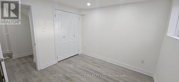 Mississauga (East Credit) townhouse for rent - A white bedroom with a closet and a window.