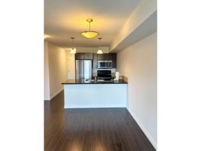 Langley apartment for rent - A modern kitchen with a white island and stainless steel appliances.
