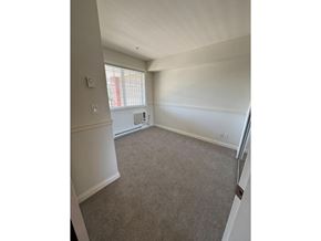 Langley apartment for rent - A room with a carpeted floor and a window with blinds.