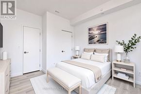 Toronto (Yonge-Eglinton) condo for rent - A bedroom with a bed, nightstand, and a painting on the wall.