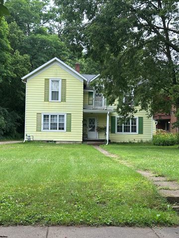 Eau Claire apartment for rent - A yellow house with a white door and windows.