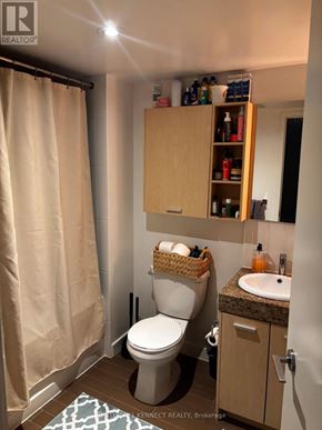 Toronto (Bayview Village) condo for rent - A bathroom with a toilet, sink, and cabinet.