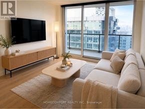 Toronto (Bayview Village) condo for rent - A living room with a large window and a flat screen TV.