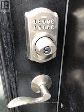 Toronto (Long Branch) apartment for rent - A door handle with a keypad lock on it.