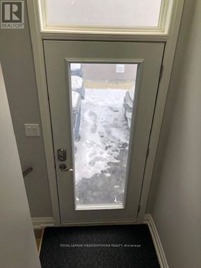 Toronto (Long Branch) apartment for rent - A door with a glass window showing a snowy scene outside.