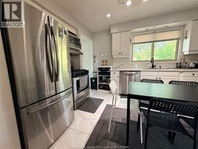 Windsor apartment for rent - A kitchen with a stainless steel refrigerator and a black dining table.