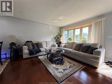 Windsor apartment for rent - A living room with a white couch and a coffee table in the middle.