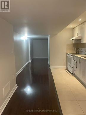 Brampton (Sandringham-Wellington) apartment for rent - A long hallway with a kitchen area at the end.