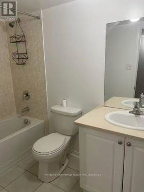 Brampton (Sandringham-Wellington) apartment for rent - A white toilet sits next to a sink in a bathroom.
