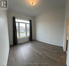 Belleville (Thurlow Ward) townhouse for rent - A room with a large window and grey curtains.