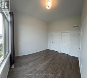 Belleville (Thurlow Ward) townhouse for rent - A room with wood flooring and white walls.