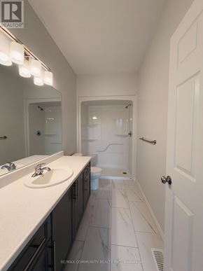 Belleville (Thurlow Ward) townhouse for rent - A bathroom with a white sink and a mirror above it.