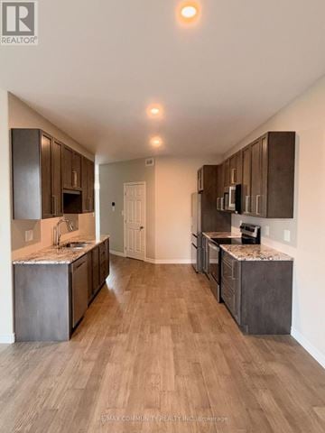 Belleville (Thurlow Ward) townhouse for rent - A modern kitchen with wooden cabinets and a marble countertop.