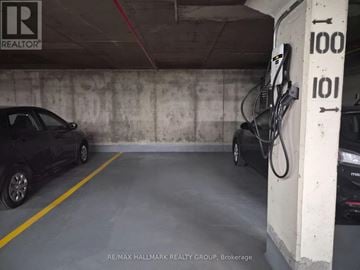 Ottawa condo for rent - A car is parked in a garage with a charging station.