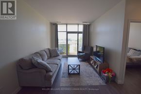 Toronto (Thorncliffe Park) condo for rent - A living room with a couch, a coffee table, and a television.