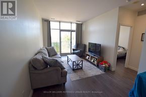 Toronto (Thorncliffe Park) condo for rent - A living room with a couch, a coffee table, and a television.
