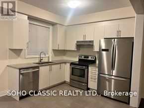 East Gwillimbury (Sharon) apartment for rent - A kitchen with white cabinets and stainless steel appliances.