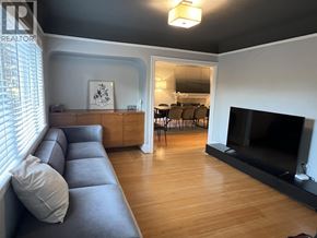 Vancouver apartment for rent - A living room with a grey couch and a fireplace.