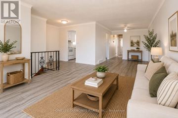 Welland (N. Welland) apartment for rent - A living room with a white couch and a wooden coffee table.