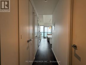 Toronto (Church-Yonge Corridor) condo for rent - A hallway with doors on both sides leading to a room with a window.