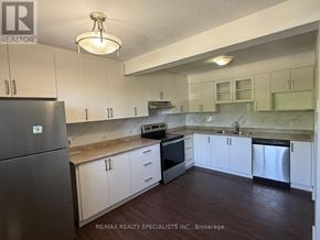 Kitchener townhouse for rent - A kitchen with white cabinets and a refrigerator.