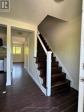 Kitchener townhouse for rent - A hallway with a staircase and a door on the right.