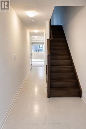 Halton Hills (Georgetown) townhouse for rent - A long hallway with a staircase on the right side.
