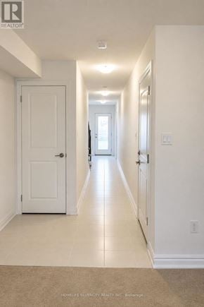 Halton Hills (Georgetown) townhouse for rent - A long hallway with white walls and a carpeted floor.