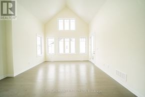 Loyalist (Bath) apartment for rent - A spacious room with wooden floors and white walls.