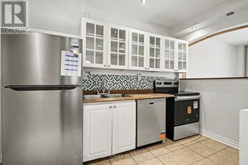 Toronto (Yonge-Eglinton) apartment for rent - A kitchen with a stainless steel refrigerator and white cabinets.