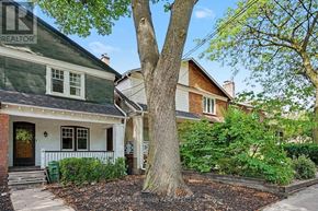 Toronto (Yonge-Eglinton) apartment for rent - A tree in front of a house with a sign that says REALTOR.