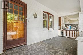 Toronto (Yonge-Eglinton) apartment for rent - A white building with a brown door and a small porch.